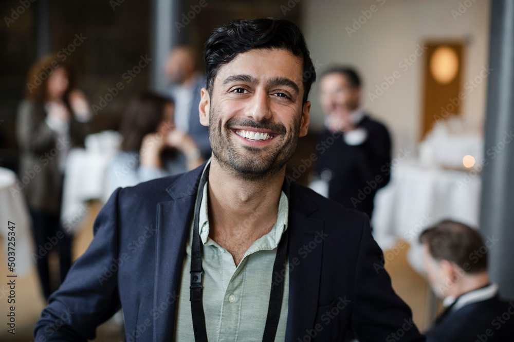 Portrait of confident businessman in blazer at seminar Portrait of confident businessman in blazer at seminar