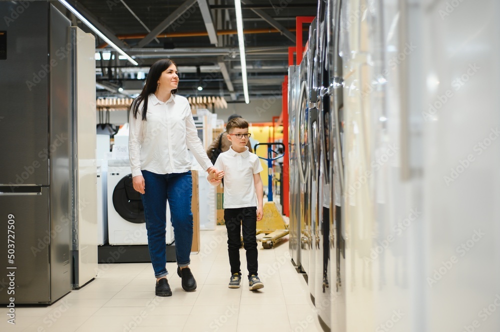 family uying domestic refrigerator in supermarket family uying domestic refrigerator in supermarket