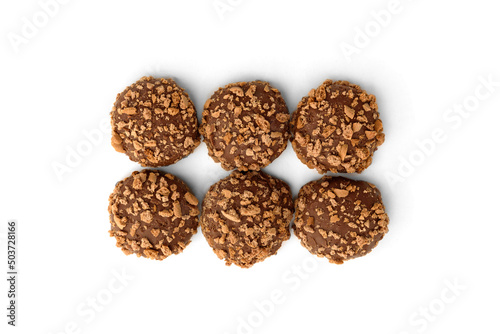 Shortbread cookies in milk chocolate glaze and crumbs isolated on white background.