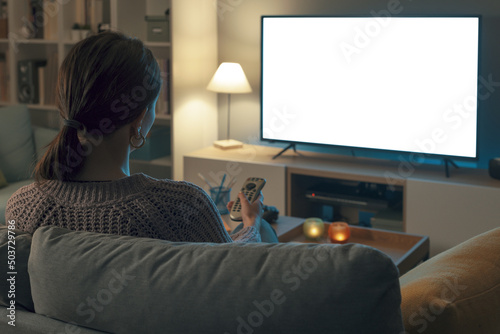 Woman watching TV and relaxing at home