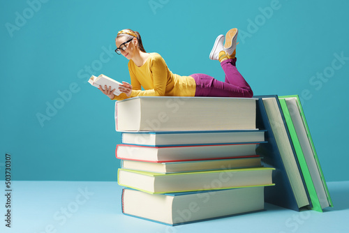 Tiny woman reading books and learning photo