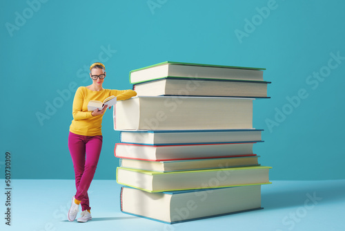 Tiny woman reading books and learning photo