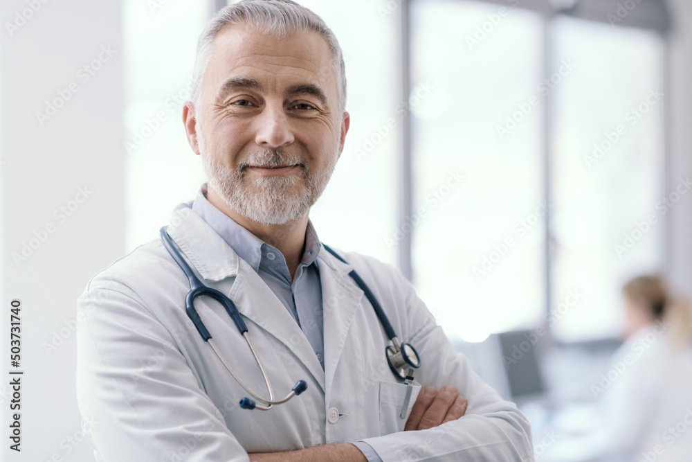 Confident doctor posing with arms crossed Confident doctor posing with arms crossed