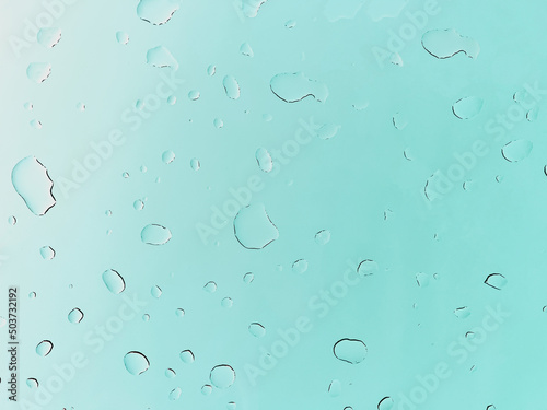 Raindrops on a green background. Raindrops on the glass. Soft focus