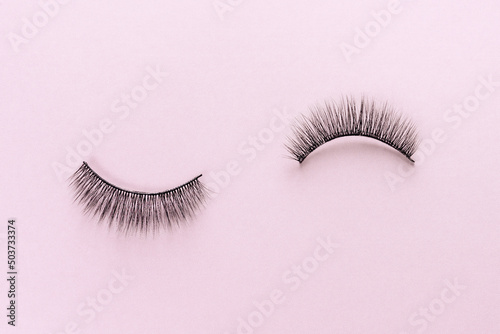 Overhead eyelashes on pink background. Makeup of female eyes. Eyelash extension. Womens cosmetics.
