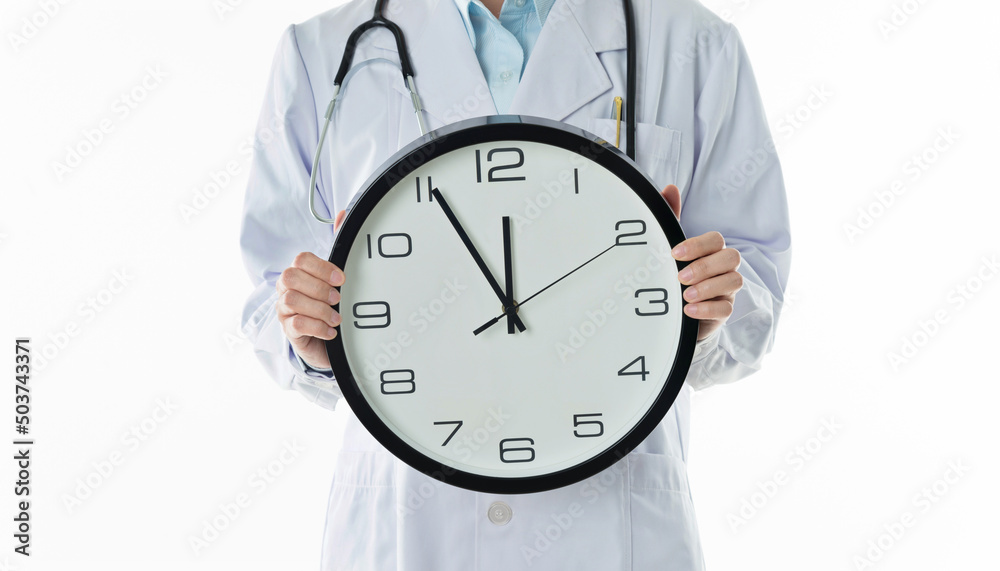 Doctor holding wall clock against white background Doctor holding wall clock against white background