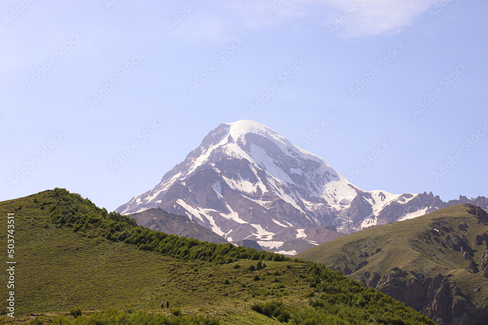 Fototapeta premium Peak Of Mount Kazbek Covered With Snow. Stepantsminda, Gergeti, Georgia.