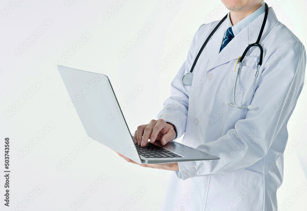 Doctor working on laptop against white background Doctor working on laptop against white background