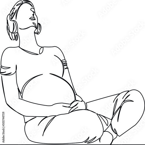 pregnant woman listening to music with headphones