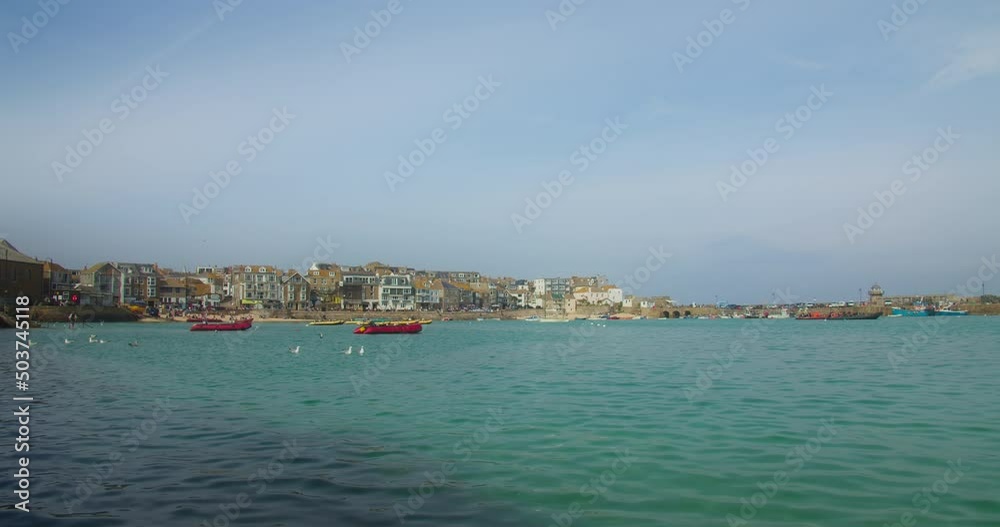 View Of St Ives Harbour Beach With Boats And Coastal Structures In Cornwall, UK. Wide Shot View Of St Ives Harbour Beach With Boats And Coastal Structures In Cornwall, UK. Wide Shot