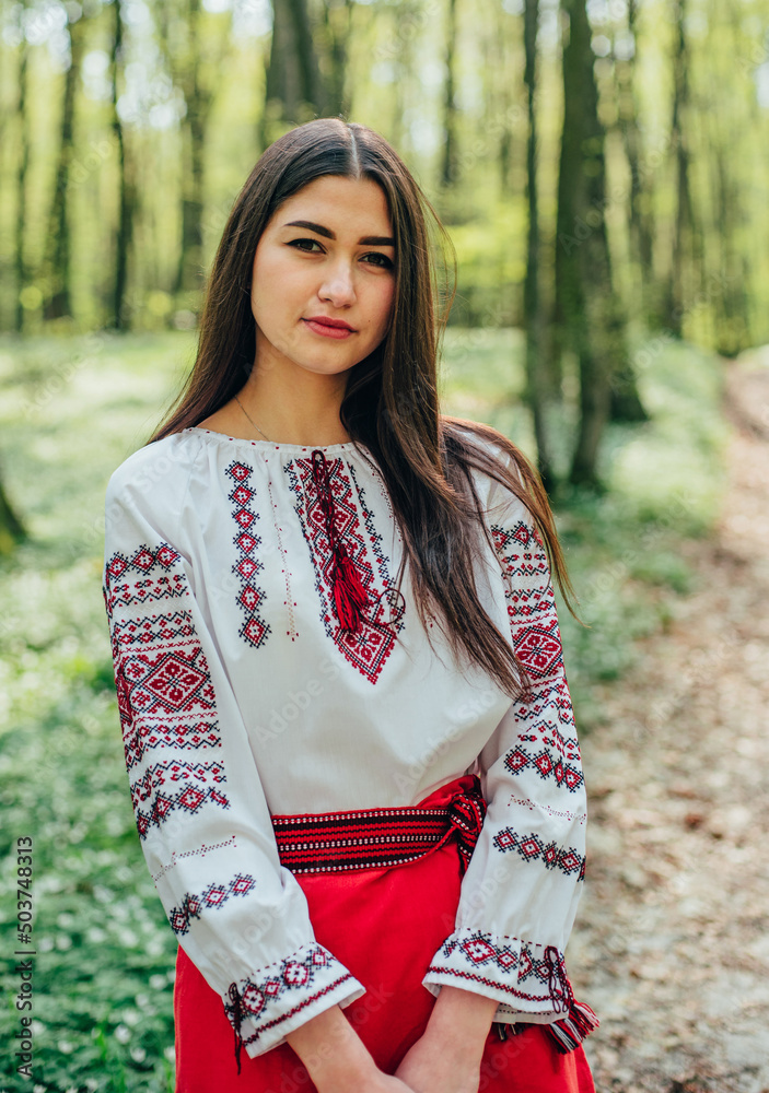 vertikal portrait of young beautiful Ukrainian woman in vyshyvanka - ukrainian national clothes. Stand with Ukraine vertikal portrait of young beautiful Ukrainian woman in vyshyvanka - ukrainian national clothes. Stand with Ukraine