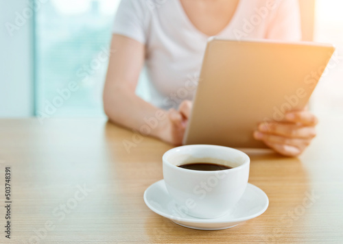 Woman using her tablet pc in cafe