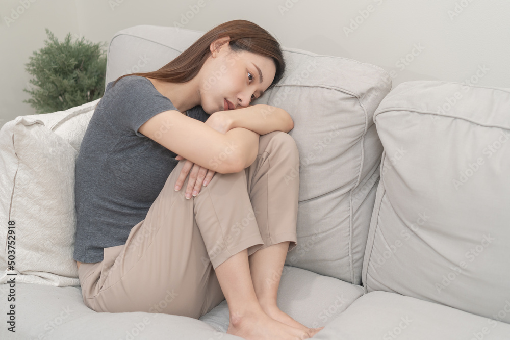 Mental health, depressed sad asian young woman, girl sitting on sofa, couch, expression to face difficulty, failure and exhausted. Thoughtful worried suffering depression feeling lonely, alone at home Mental health, depressed sad asian young woman, girl sitting on sofa, couch, expression to face difficulty, failure and exhausted. Thoughtful worried suffering depression feeling lonely, alone at home