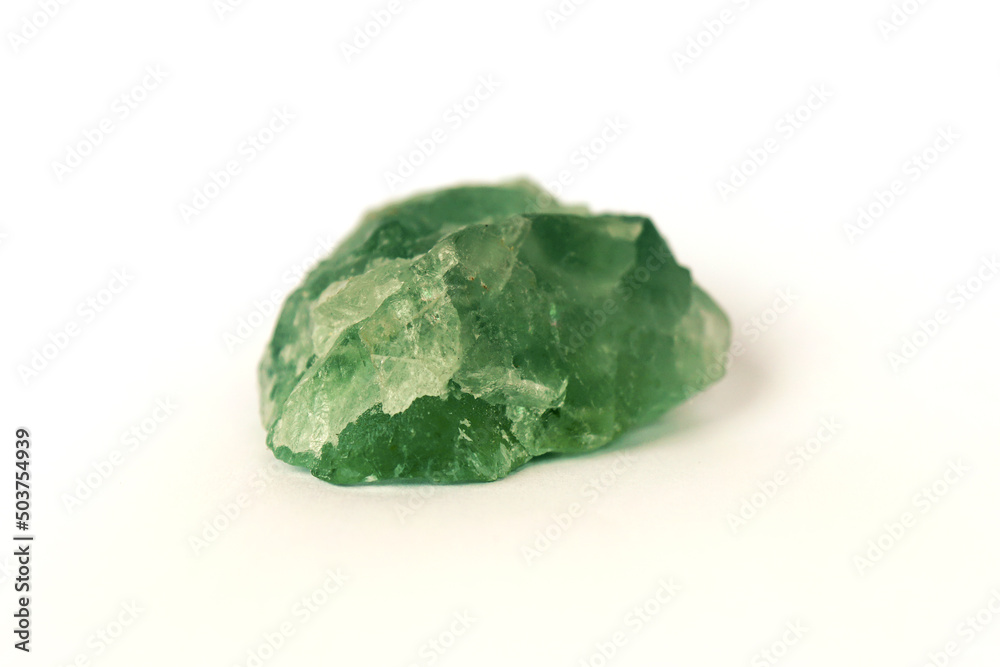 macro shooting raw gemstone of green fluorite rock isolated on white background. macro shooting raw gemstone of green fluorite rock isolated on white background.