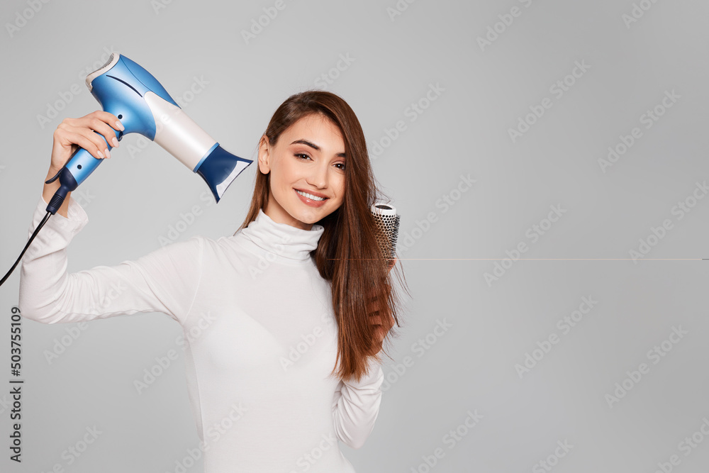 attractive cheerful lady drying strong healthy hair attractive cheerful lady drying strong healthy hair