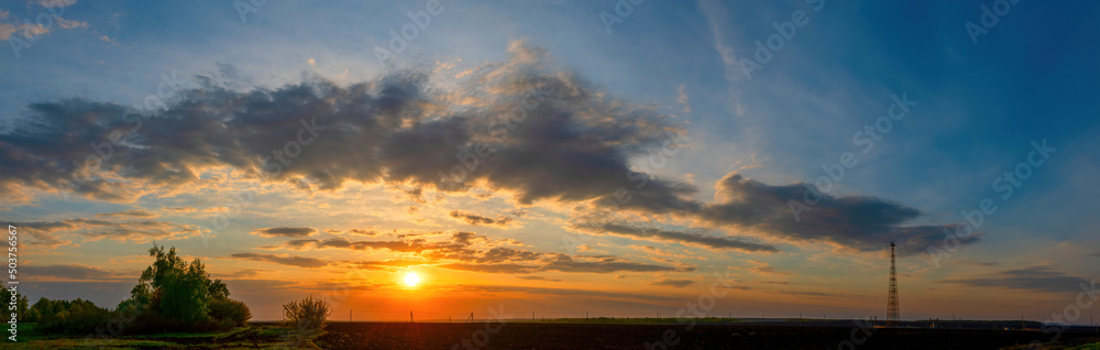Natural Sunset Sunrise Over Field Or Meadow. Bright Dramatic Sky Over Countryside Landscape Under Scenic Sky At Sunset Dawn Sunrise. Skyline, Horizon