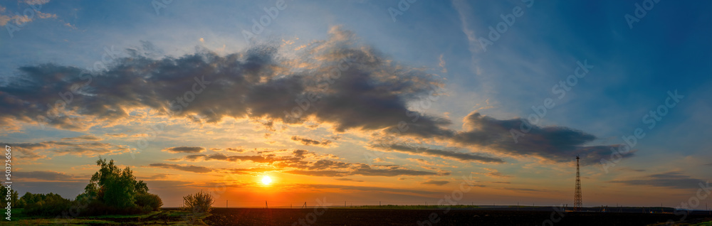 Natural Sunset Sunrise Over Field Or Meadow. Bright Dramatic Sky Over Countryside Landscape Under Scenic Sky At Sunset Dawn Sunrise. Skyline, Horizon Natural Sunset Sunrise Over Field Or Meadow. Bright Dramatic Sky Over Countryside Landscape Under Scenic Sky At Sunset Dawn Sunrise. Skyline, Horizon