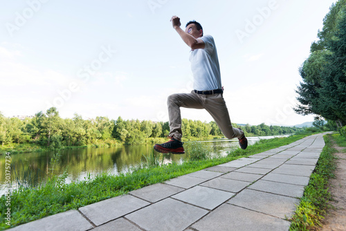 Young man running at the lake