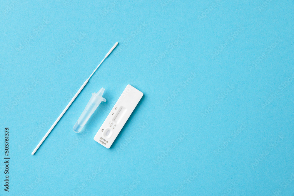 Covid-19 self-test kit, blue background, copy space. Covid-19 self-test kit, blue background, copy space.