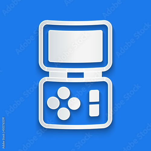 Paper cut Portable tetris electronic game icon isolated on blue background. Vintage style pocket brick game. Interactive playing device. Paper art style. Vector