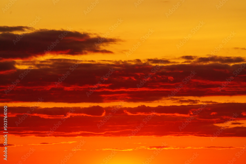 Fototapeta premium Colorful sunset in the evening sky. Great dramatic view. Clouds illuminated by the setting sun. Amazing sky panorama. Meditative calmness and greatness. Mystical lighting