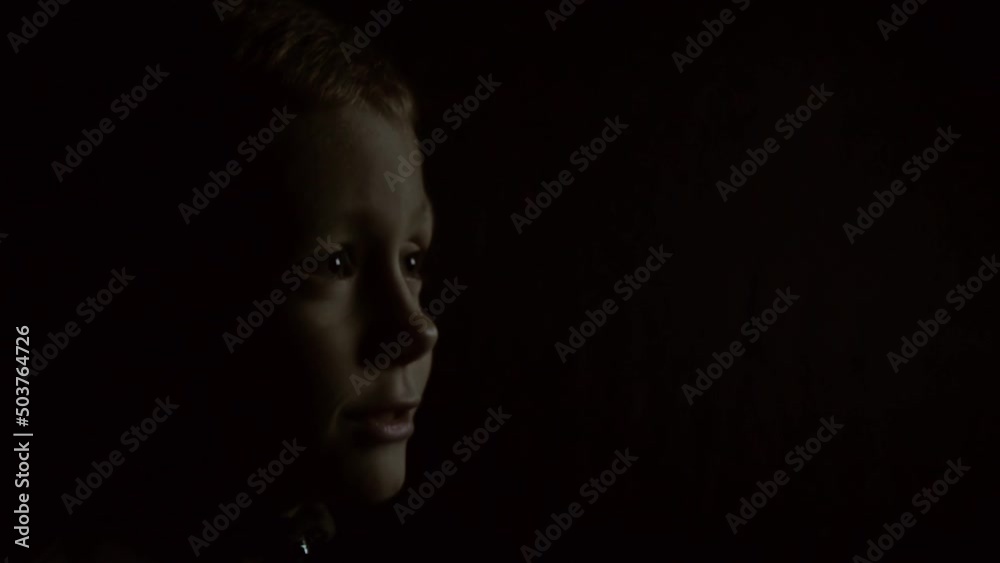Kid watching TV in the dark