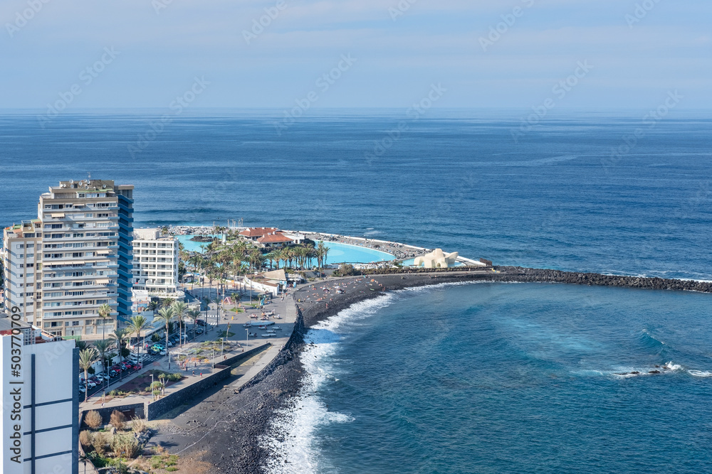 Views from Mirador de la Paz towards the charming town featuring hotels, a black sand beach and the water park Lago Martianez, Puerto de la Cruz, Tenerife, Canary Islands, Spain