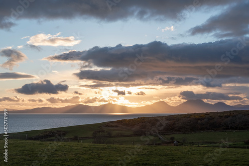 Fabulous sunset near Kilberry village in Argyll and Bute, with crepuscular rays piercing through the heavy dark clouds, beautiful twilight over one of the most remote parts of the Scottish Highlands