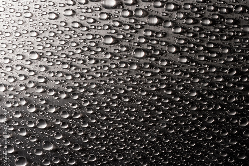 Abstract background with drops of water on metal flat surface