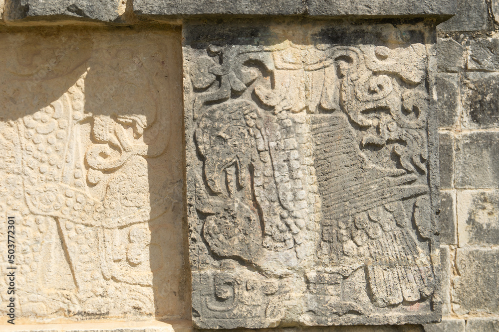 Closeup view of details on the platform of the Eagles and Jaguars in the Mayan ruins in the Great Plaza in the Chichen Itza, Mexico. Engraving depicted on the platform for sacrifices.