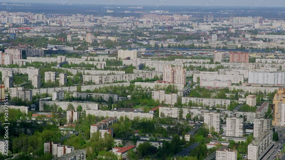 A view from a helicopter flying over an urban area on sunny summer day. Flying past brick houses of Soviet architecture again background big city. A bird's-eye view of city landscape. Saint-Petersburg A view from a helicopter flying over an urban area on sunny summer day. Flying past brick houses of Soviet architecture again background big city. A bird's-eye view of city landscape. Saint-Petersburg