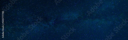 Starry Milky Way at night with stars on the background of a dark blue night sky © alexkoral