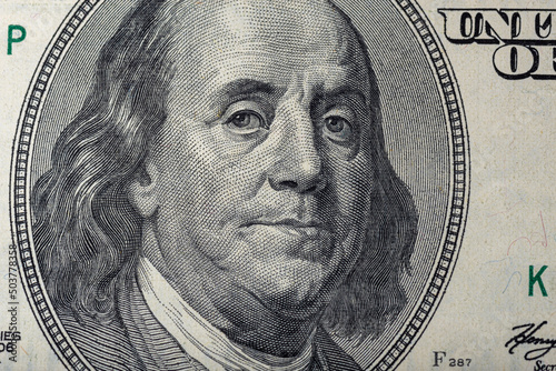 Portrait of Ben Franklin on the US 100 dollar bill in macro. Benjamin Franklin on hundred dollar American banknote.