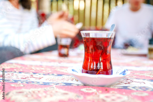 Traditional Turkish tea. Bardak - a glass in the shape of a tulip. Excellent delicious breakfast on the coast. Unforgettable view in Turkey. Strong sweet tea is a landmark of Turkey and Istanbul