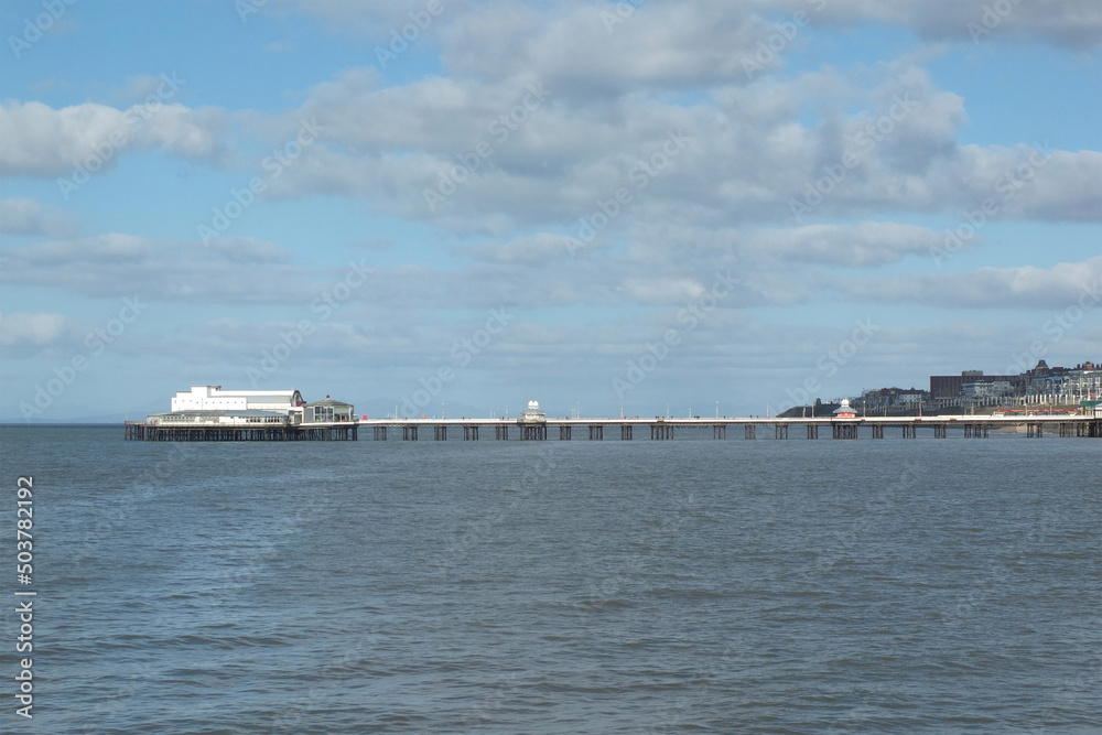 view of blackpool North pier at high tide with town buildings