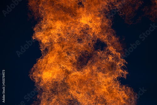 Gas burning, fire flame on sky in the background