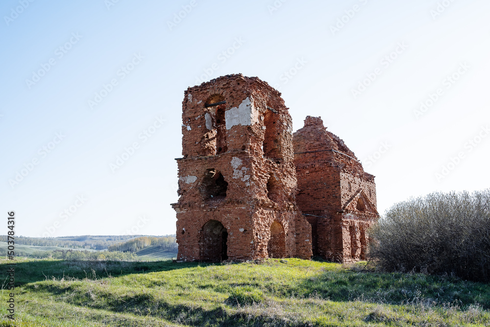 The old Church is Christian, the ruins of an Orthodox church stand in an empty field. A ruined red brick building, Russia is a place to worship.
