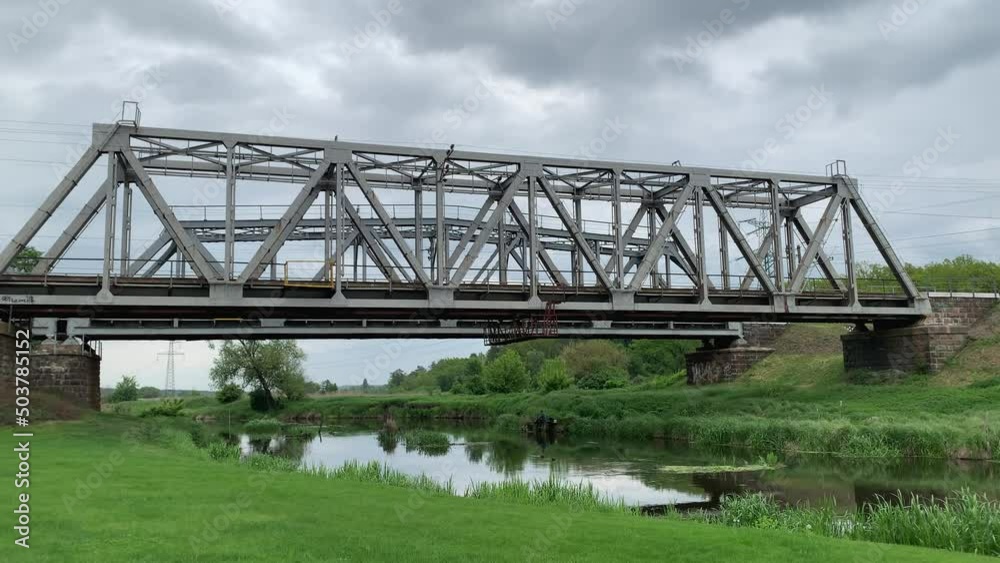 Railway bridge across the Irpen River before the war in Ukraine. Cloudy spring weather. Railway bridge across the Irpen River before the war in Ukraine. Cloudy spring weather.