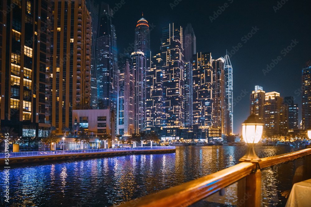 Night View Of City Skyline From Tourist Boat, Sightseeing Boat Sailing On Dubai Marina. Night Walk Of Dubai Marina Is District in Dubai, United Arab Emirates. Vacation In UAE. Holidays In United Arab