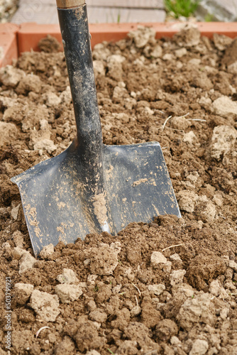 Digging soil with shovel. Shallow depth of field