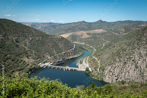 Entre montes e montanhas o rio Douro e ao fundo a barragem hidroelétrica da Valeira em Trás os Montes, Portugal photo