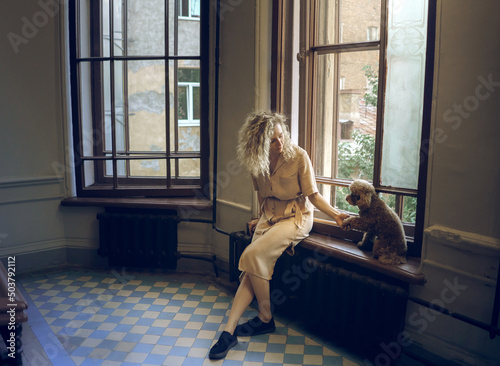 Photography girl and two dogs in the city stairwell inside for a walk