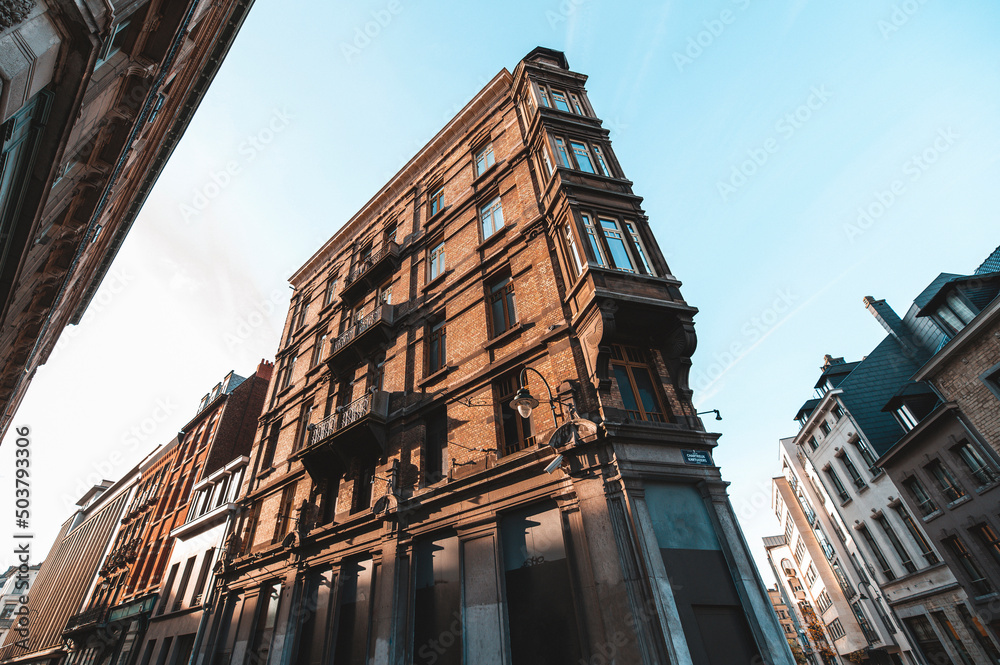 Fototapeta premium Typical Brussels apartment building in the city center with warm sunlight