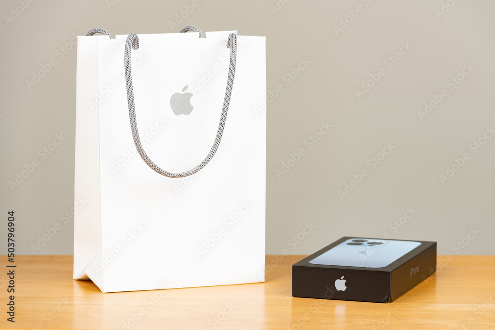 Apple Store white shopping bag with an iPhone 13 Pro box on a