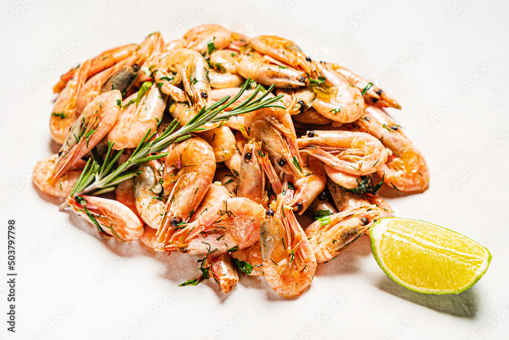 shrimps with lime dressing on the wooden background