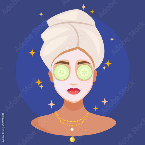 Young woman with a towel on her head and a cosmetic facial sheet mask