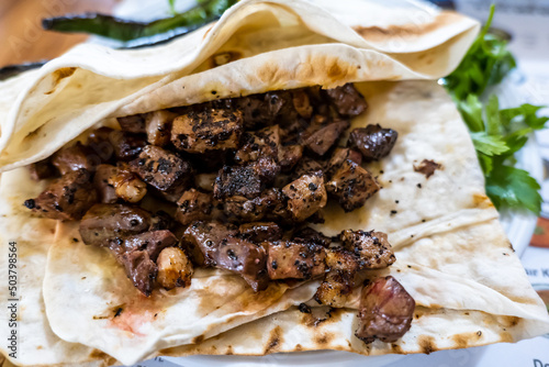 Ciger kabab (Ciğer kebabı in Turkish),  a common type of skewered meat served in Anatolian cuisine, usually eaten with sliced onions, salad and bread photo