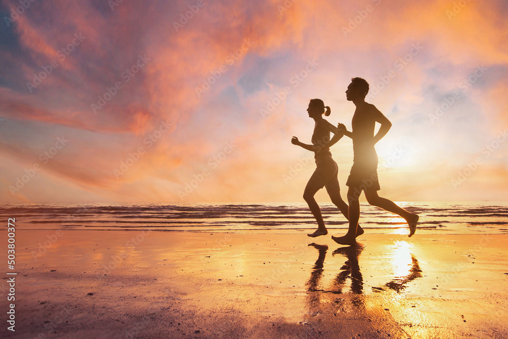 couple running, silhouettes of man and woman jogging at sunset beach