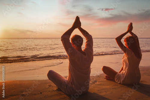 Canvas yoga lotus on the beach, couple silhouettes