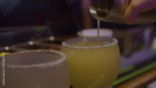 Pouring Margarita into salted glass